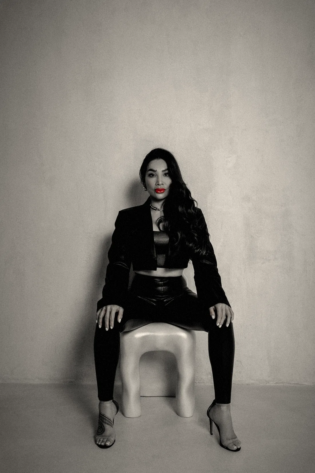 Chayenne Mallari seated facing the camera on a white stool