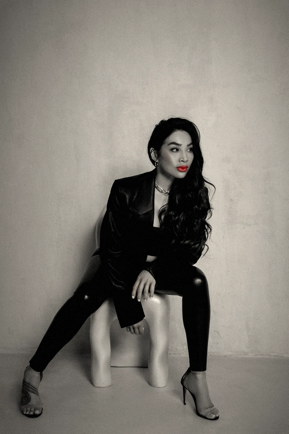 Chayenne Mallari seated on a white chair, looking away from the camera